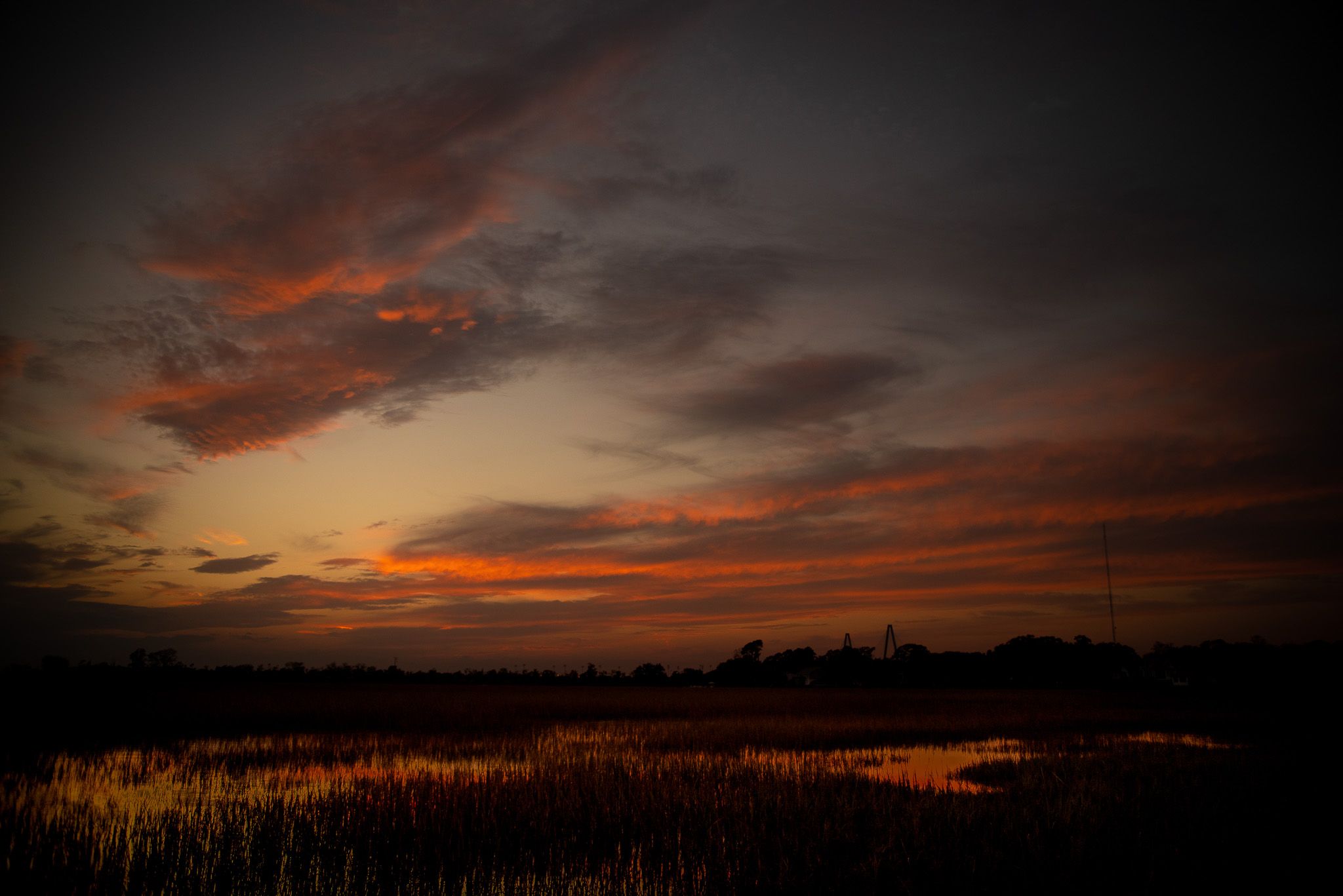 Sunset reflection over marsh water at Shem Creek in Mount Pleasant, South Carolina.
